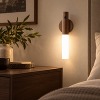 Warm wood magnetic motion sensor night light glowing in a softly styled bedroom