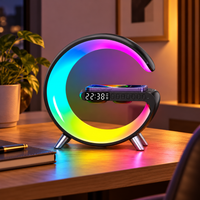 G-shaped LED lamp with wireless phone charging and speaker on a warm desk
