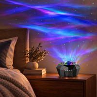 Black ocean wave star projector casting soft blue and violet patterns in a bedroom